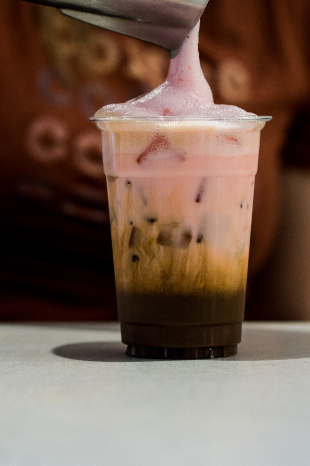 A pink iced drink on the counter